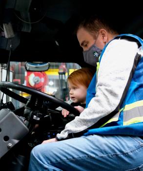 Dad and son in waste truck