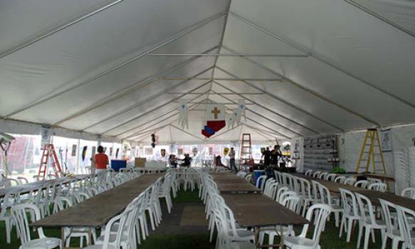 tables and chairs under a huge tent
