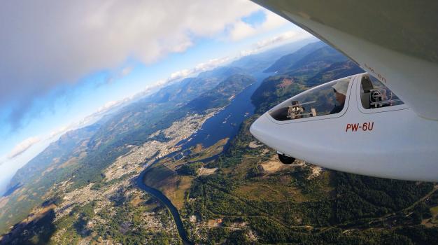 A glider banks over the town of Port Alberni