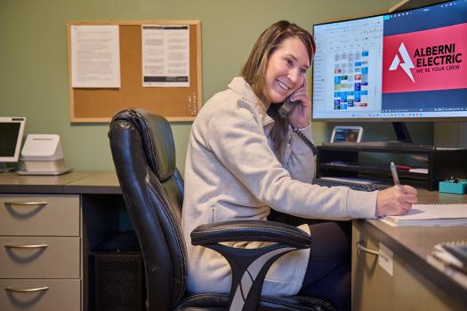 Admin answering calls in the office