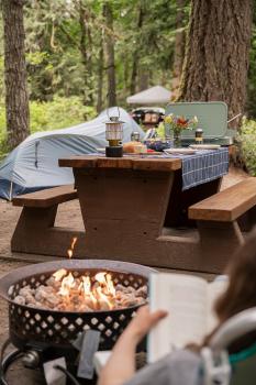 photo of picnic table with propane fire in forfront