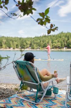 person enjoying an chair infront of water